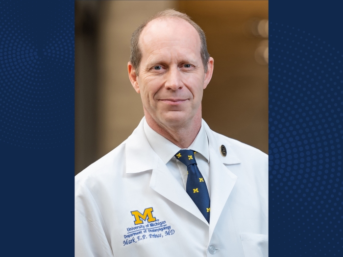 Headshot of Mark Prince, MD on a navy blue background