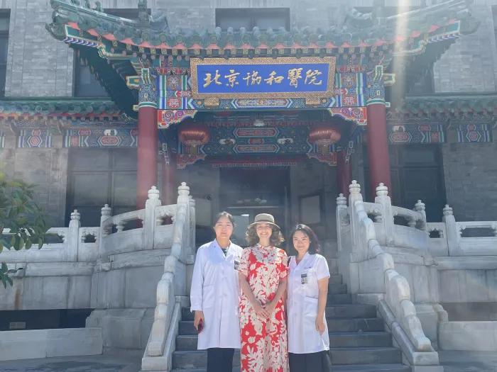 Three people standing outside the west gate of Peking Union Medical College