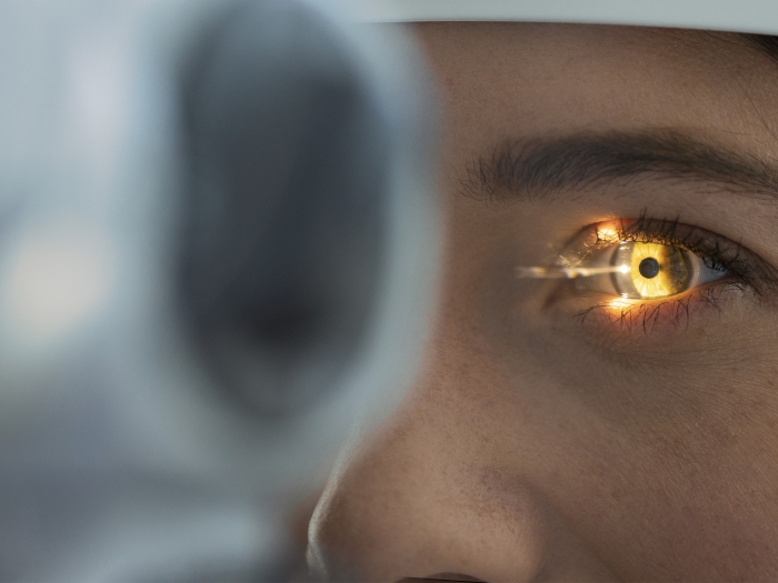 eye flashlight in exam close up of woman's eye