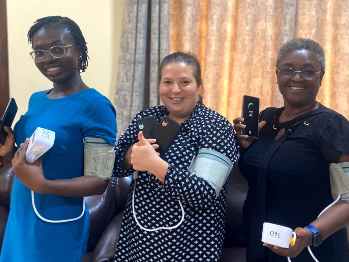 Dr. Lawrence shows off her team's Bluetooth-enabled blood pressure monitors with two of her Ghanaian collaborators, Betty Nartey (left) and Amanda Adu-Amankwah (right). 