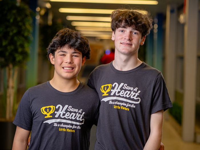 Cruz and Brady stand together in blue Save A Heart t-shirts.