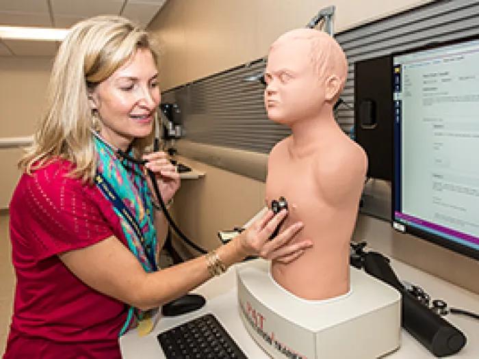 A person working with a lab dummy