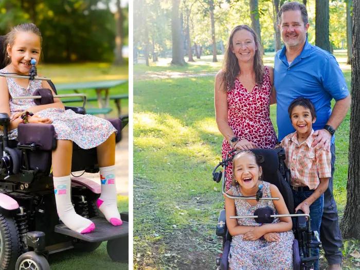 girl in wheelchair and family on right smiling for photo outside