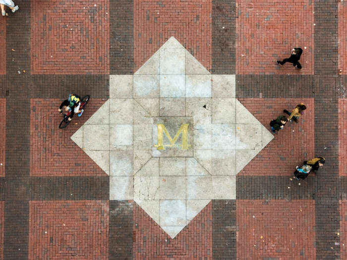 People walking and biking across the U-M diag