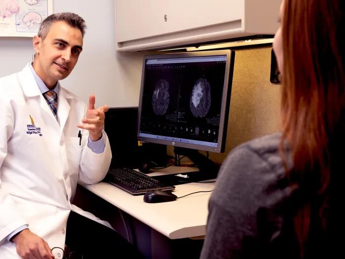 doctor talking to patient in clinic in white coat