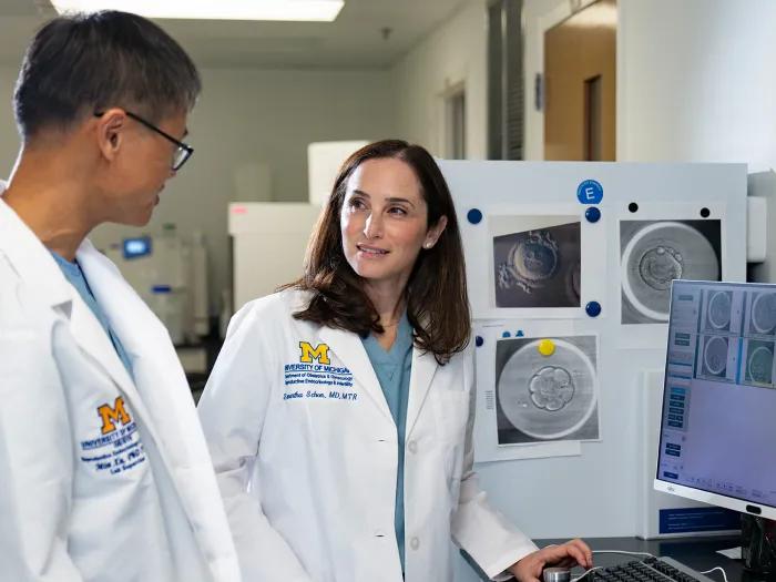 Dr. Schon and team member talking and looking at computer in clinic