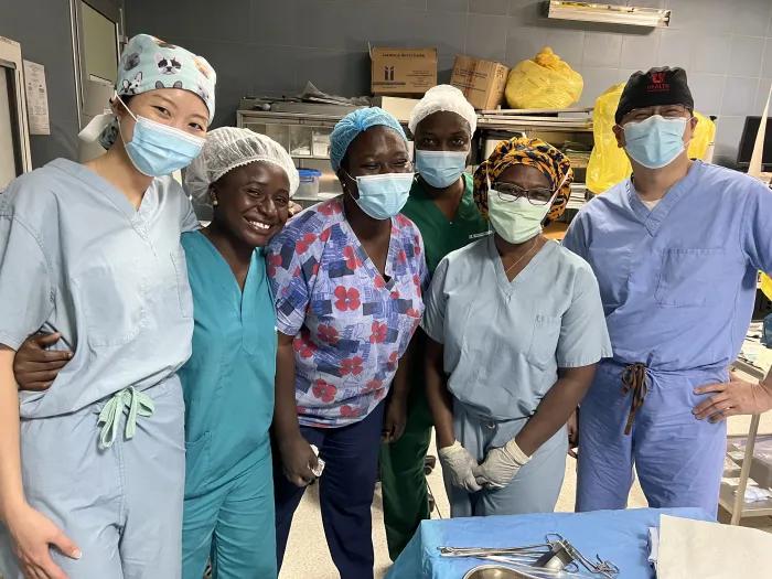 Six medical professionals wearing scrubs and surgical masks