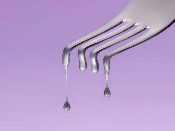 fork dripping purple background