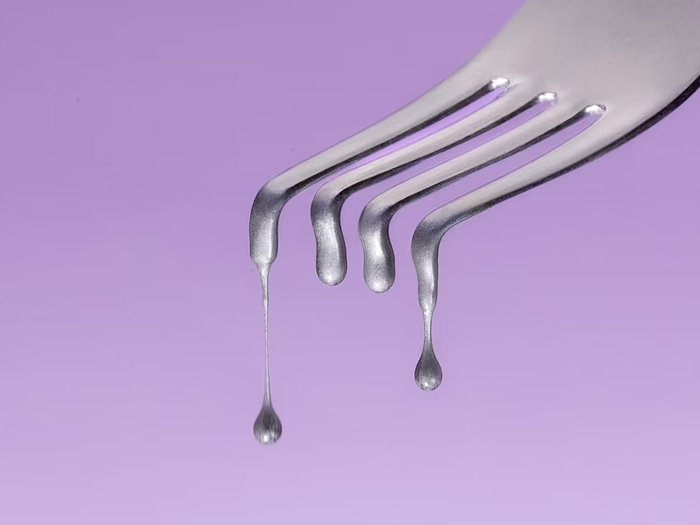 fork dripping purple background