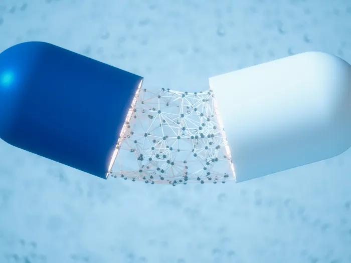 blue and white pill being broken and dots falling out in middle