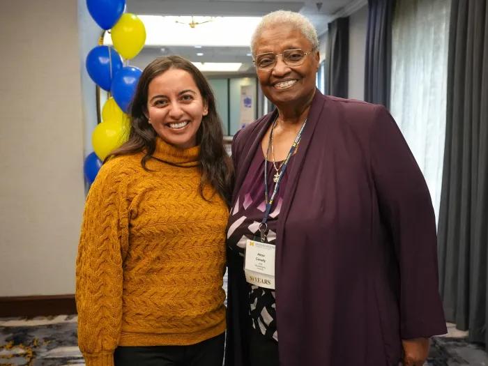 woman posing with woman smiling