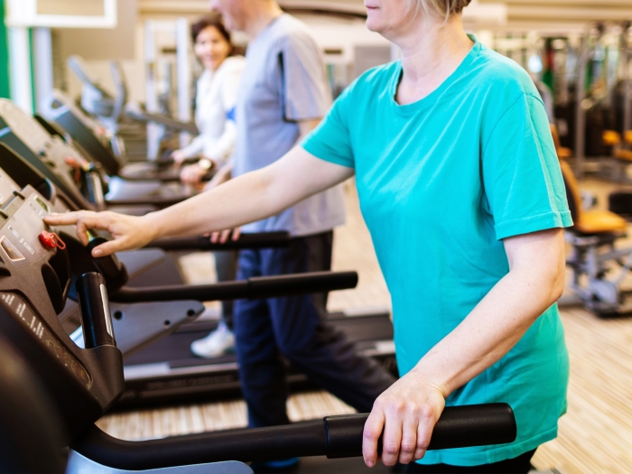 woman on treadmill with teal shirt