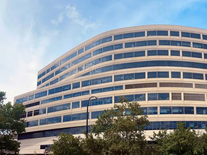 D. Dan and Betty Kahn Health Care Pavilion with blue sky, clouds, sunshine, and trees