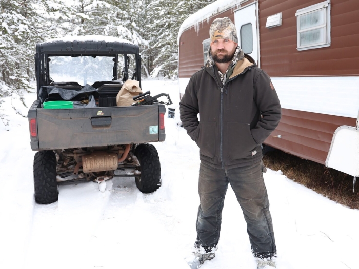 man standing outside in snow looking at camera 