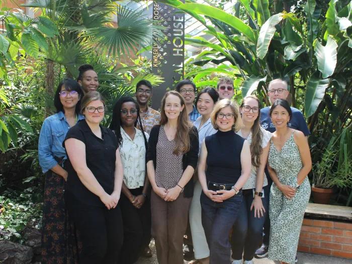 The Mixed Methods team, a group of people of various sexes and ages, standing in front of tropical plants