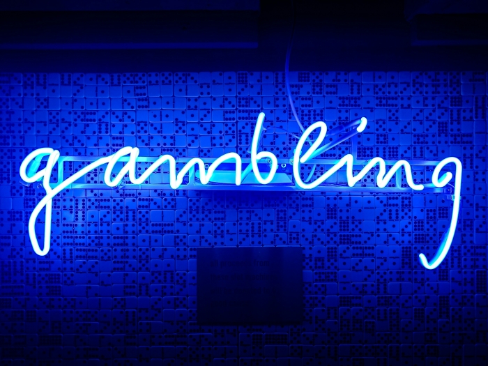 a neon sign that spells out the word "gambling"