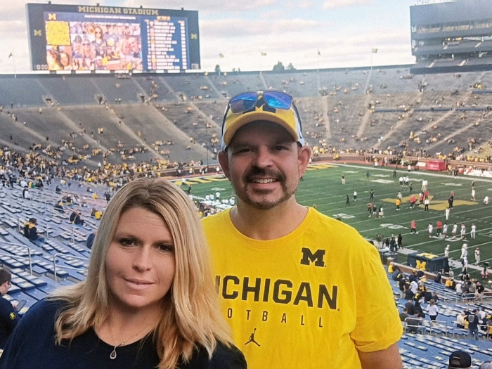 couple smiling at michigan game