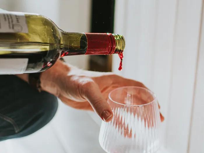 wine being poured into glass 