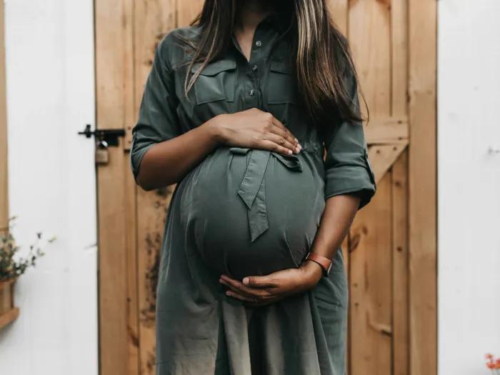 Pregnant woman holding belly