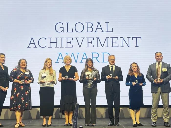 Dr. Melissa Elafros on stage receiving her Global Achievement Award with the other recipients.