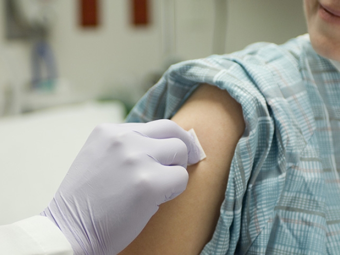 Pregnant woman receives her flu shot and Tdap vaccine during her third trimester