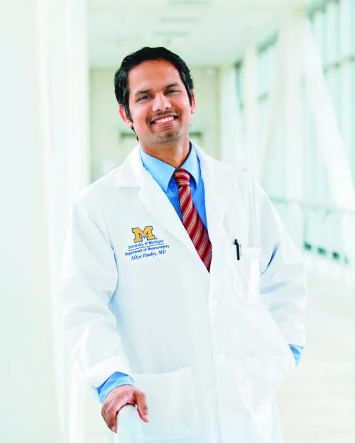a person in a white coat smiling