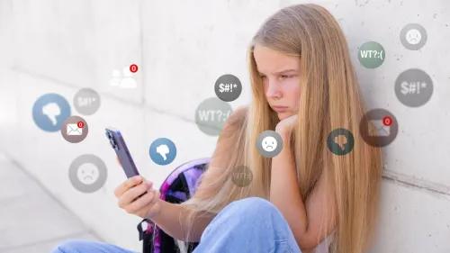 Teen girl sitting and looking at a smart phone