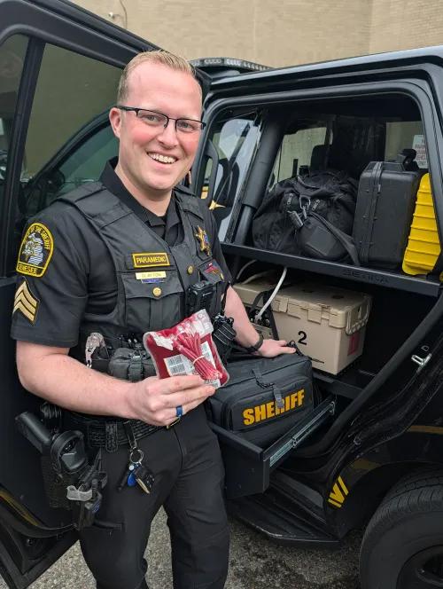 Police officer holds a bag of blood.
