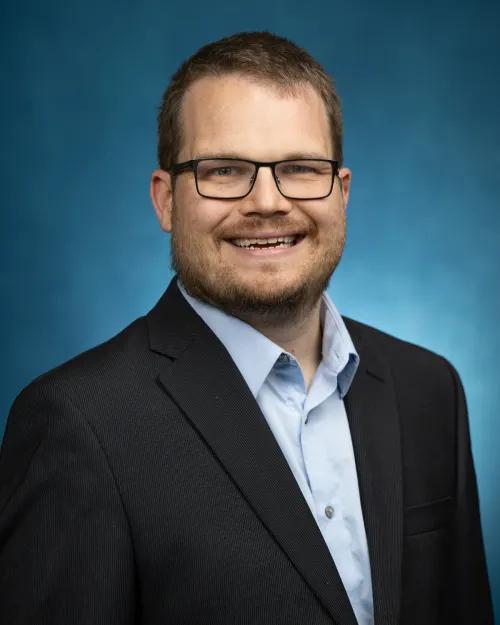 Professional portrait with blue background
