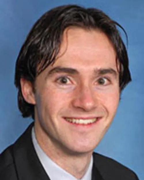 Head and shoulders photo on blue backdrop