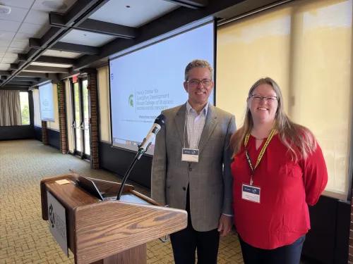 Dr. Phil Rodgers and Dr. Laurie Buis standing at a podium