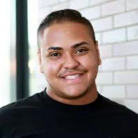 Young man with dark hair wearing a black T-shirt