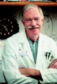 Dr. Burney smiling with arms crossed