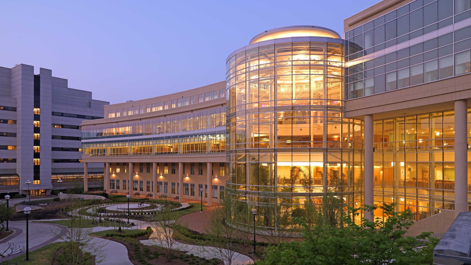 exterior view of cardiovascular center at dusk with views of spiral garden and interior atrium 