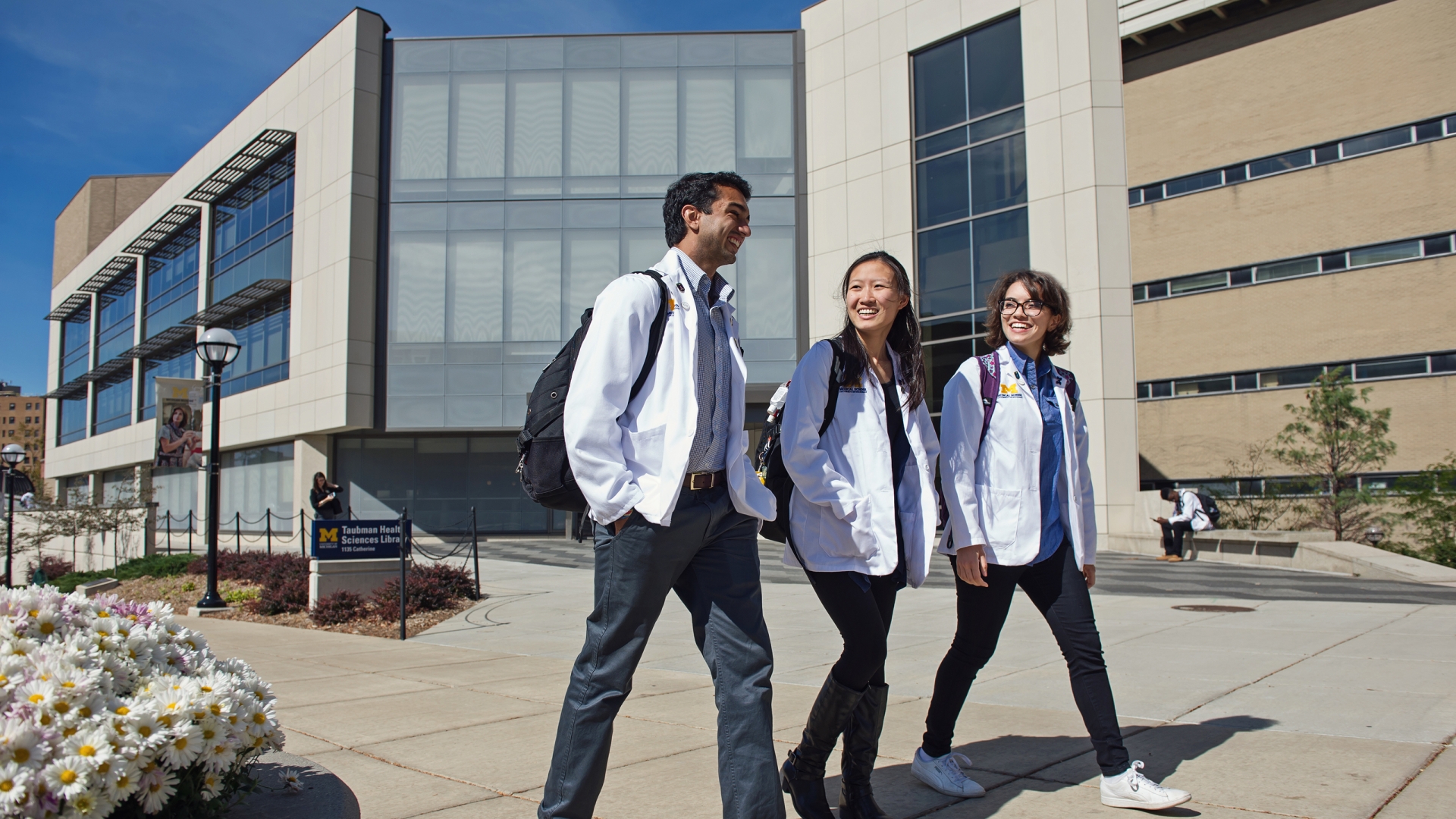 med students walking in front of the tuba health sciences library 