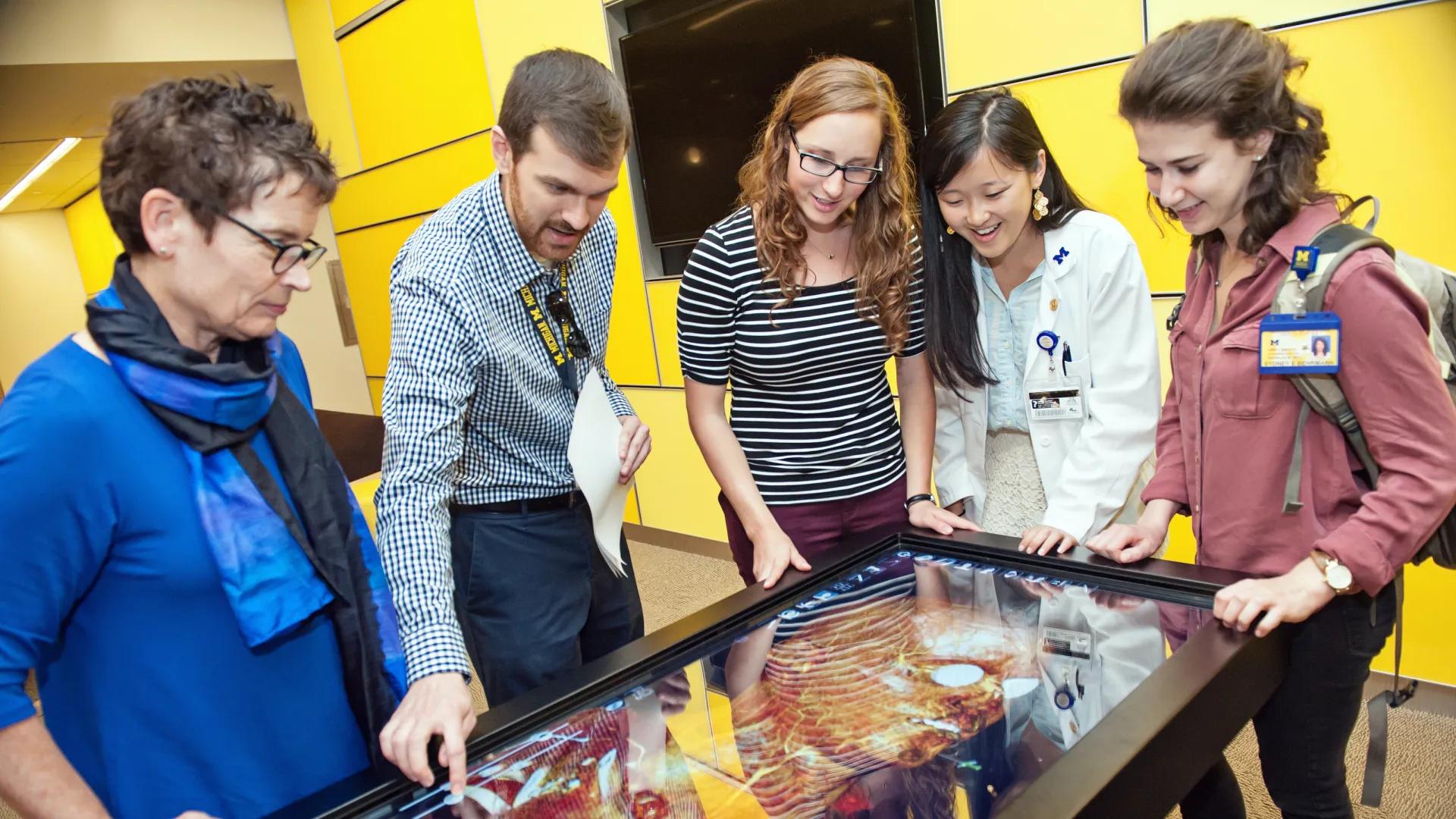 students looking at outline of body 