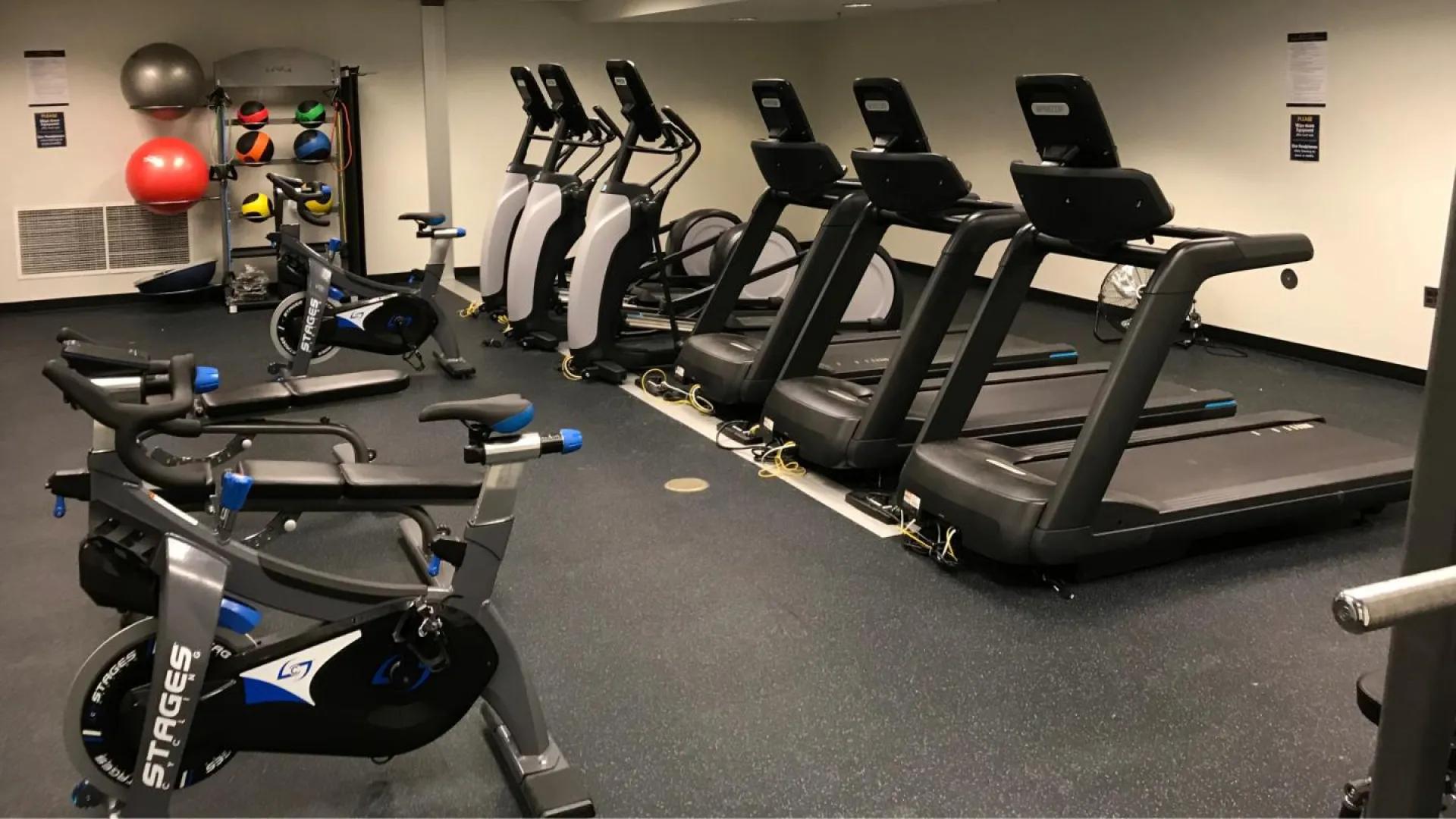 med school fitness center with row of treadmills 