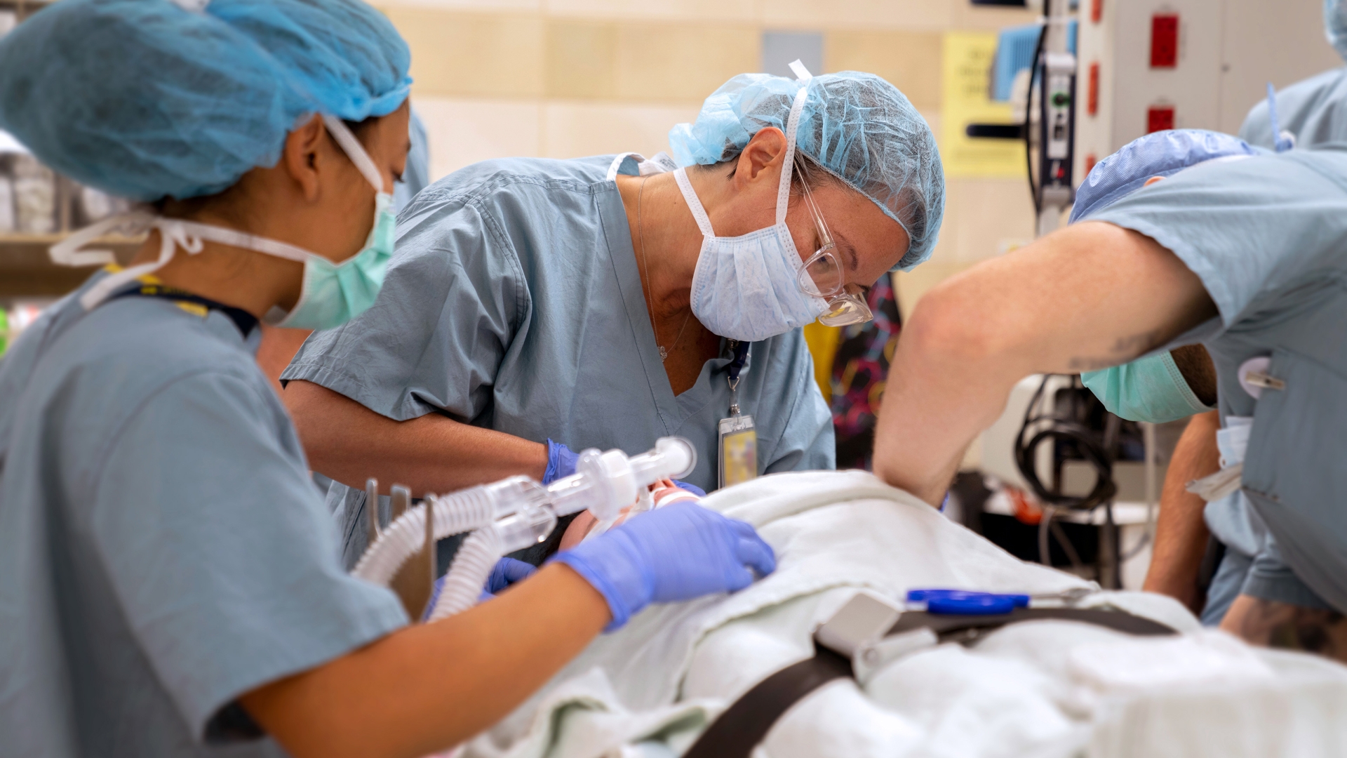 a group of people wearing surgical masks and scrubs performing a halo procedure