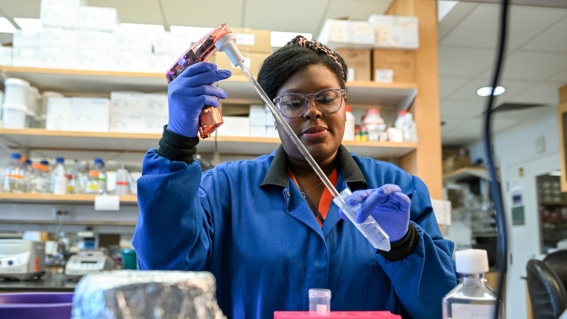 Woman in Gallagher lab using pipette 