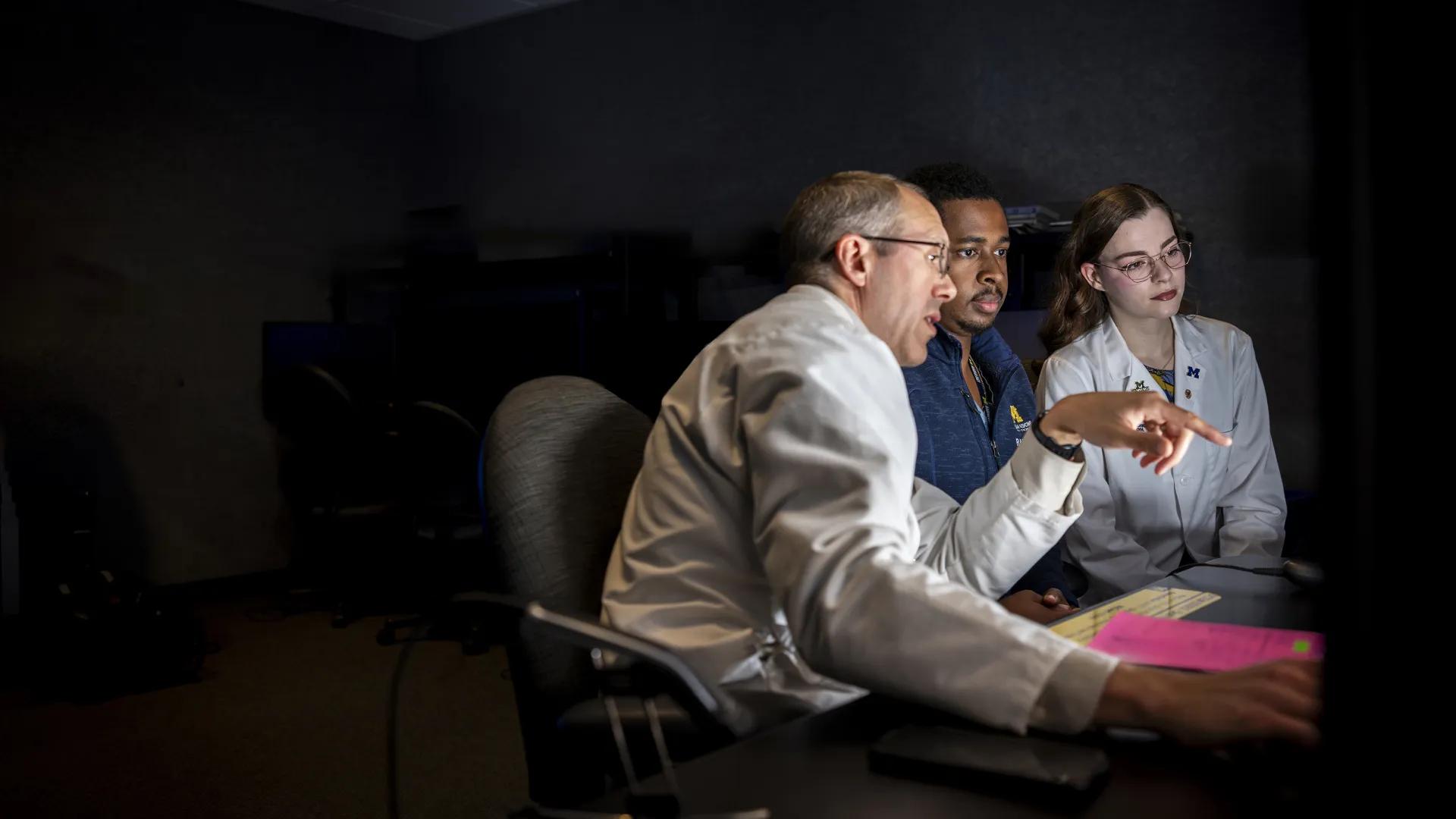 Faculty, resident and medical student viewing images in reading room