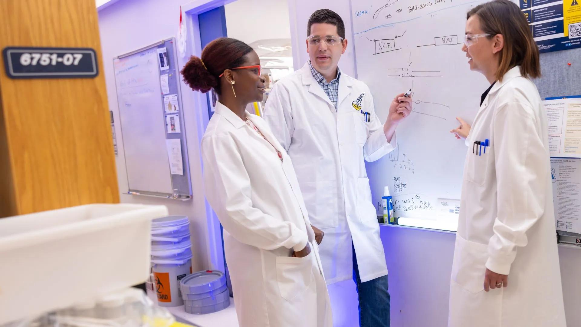 People in white coats speaking together
