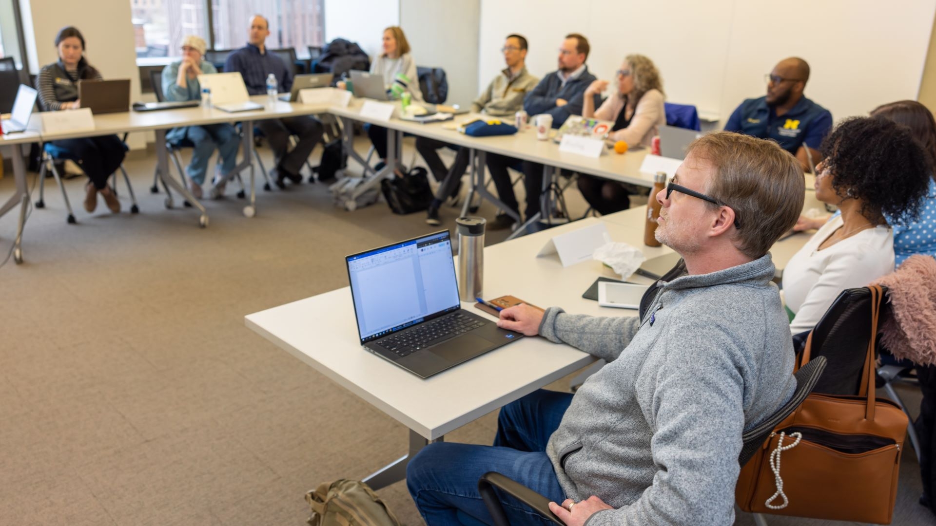 A group of people listening to a lecture