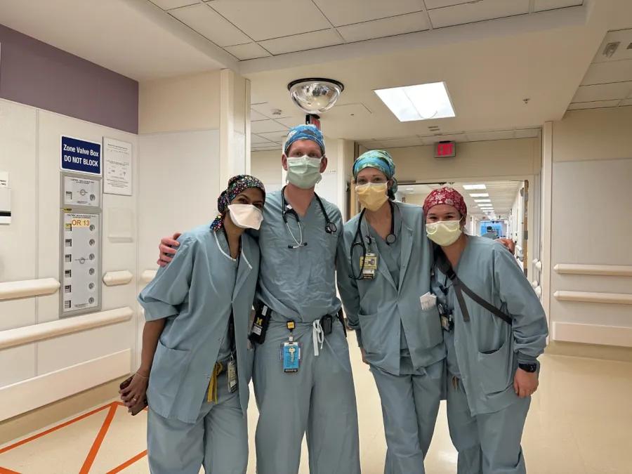 Group photo of anesthesiology nurses standing together in surgery hallway 