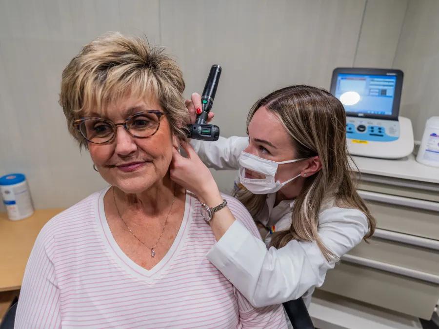 A female patient gets an ear examined