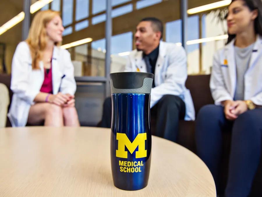 Providers having a conversation around table at hospital