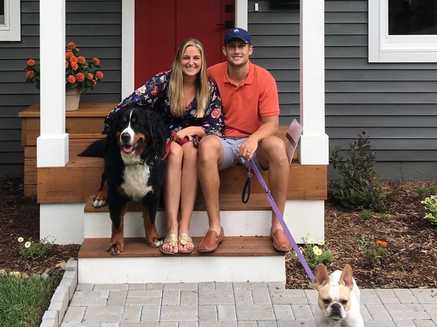 People sitting on the front step of a home
