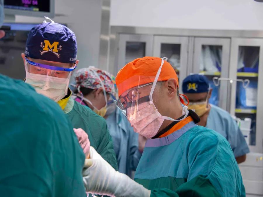 a group of surgeons wearing scrubs and face masks