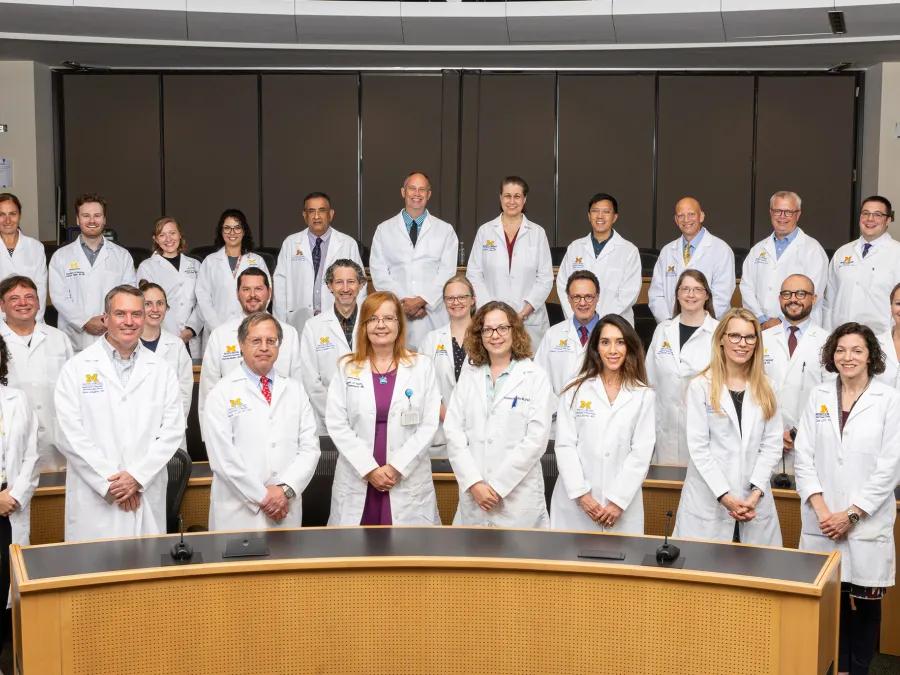a group of people in white lab coats