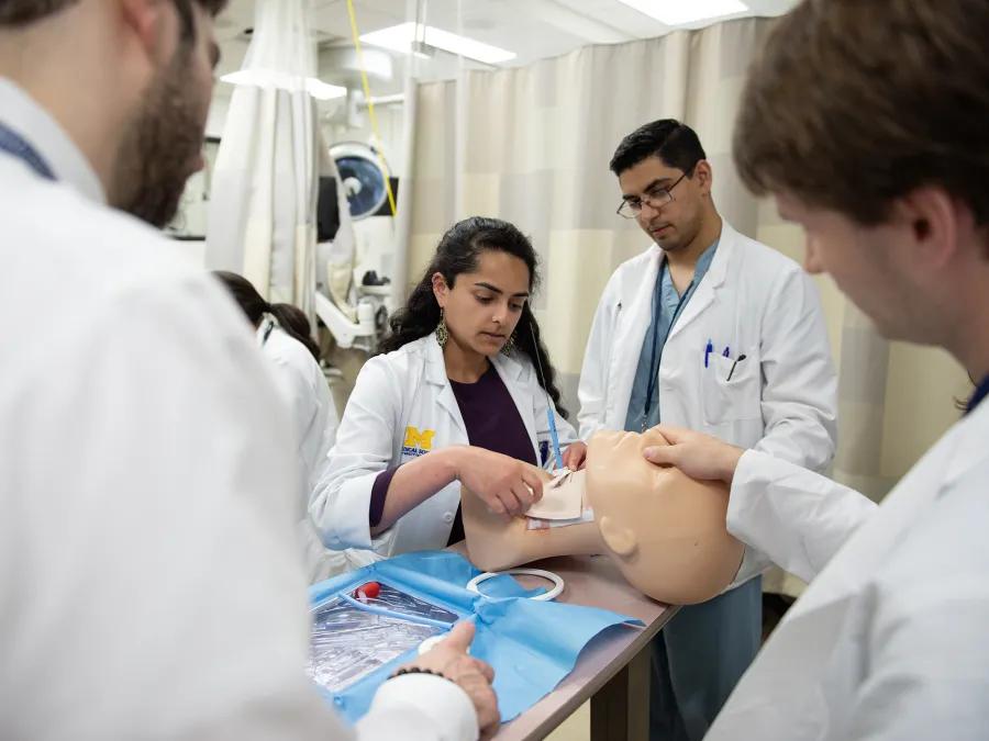 woman in sim lab practicing placing tube on simulation head