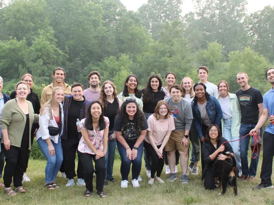 family medicine residents outside in group photo with a dog
